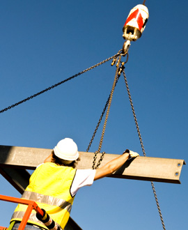 A construction worker rigging a load